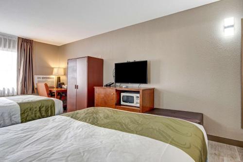 a hotel room with two beds and a flat screen tv at Quality Inn near Mesa Verde in Cortez