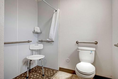 a small bathroom with a toilet and a stool at Quality Inn near Mesa Verde in Cortez
