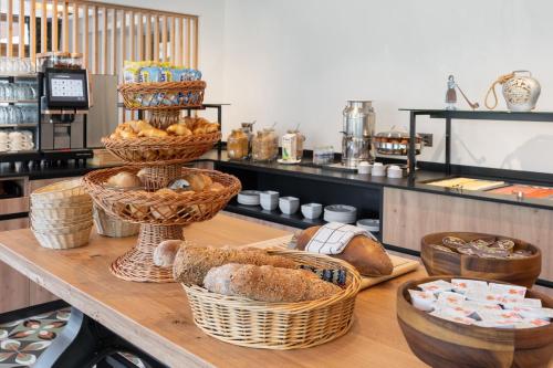 a counter with baskets of bread and other items at Jungfrau Lodge, Annex Crystal in Grindelwald