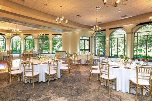 a banquet hall with tables and chairs and windows at Hilton Vacation Club Mystic Dunes Orlando in Orlando