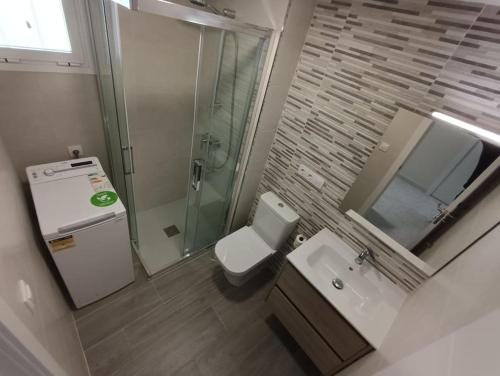 a bathroom with a toilet and a sink and a shower at MobyDick 10B in Benidorm