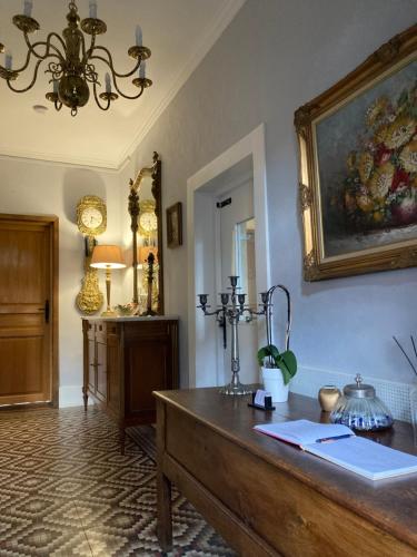 a room with a table and a painting on the wall at La Ruche, Chaillac in Chaillac