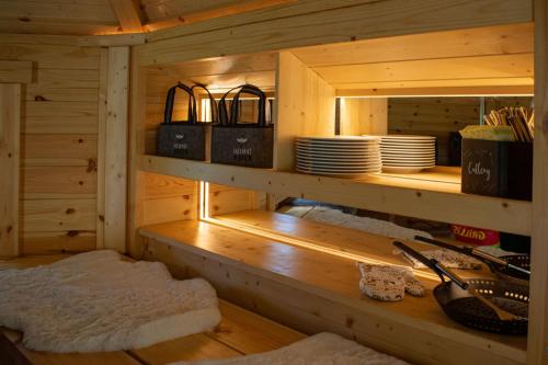 a wooden cabin with a counter with plates and dishes at Ferienwohnungen Bosserthof in Donaueschingen