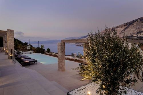 a resort with a pool and a view of the ocean at Villa Electra Zola in Zóla