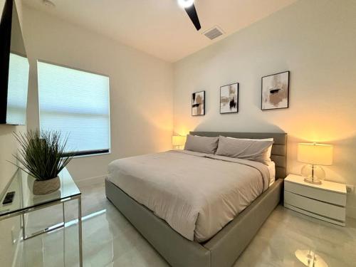 a bedroom with a large bed and a window at Villa Twenty Two by CoralVilla - modern, pool & spa in Shell Point Village