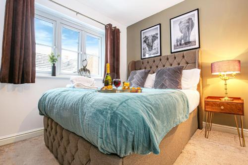 a bedroom with a bed with a tray of food on it at Detached 4 Bed-UltraFast Wifi Garden Free Parking in Milton Keynes