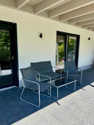 two chairs and a table on a patio at Wohnung am Wald in Geisa