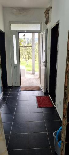an empty hallway with a door open to a yard at Milan Apartman in Podgorica