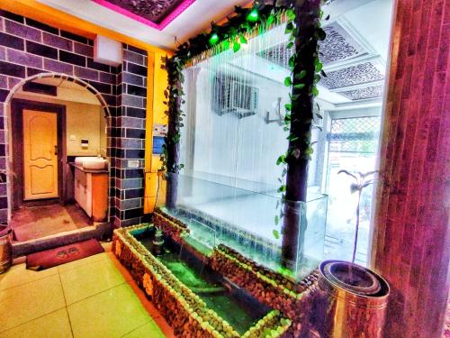 a room with a large aquarium in the middle of a house at Abeer Hotel Swat by Khan Familia Travels in Swat