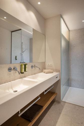 a bathroom with a sink and a mirror at Heilthermen Resort Bad Waltersdorf in Bad Waltersdorf