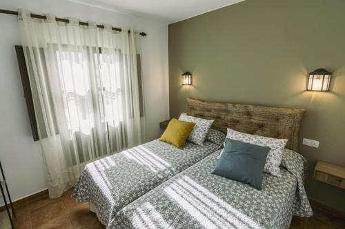 a bedroom with two beds and two pillows at Finca Campo Alegre in Utrera