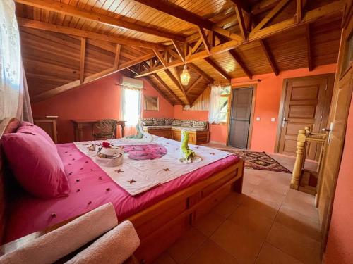a large room with a large bed with a pink sheet at Homekemer A in Kemer