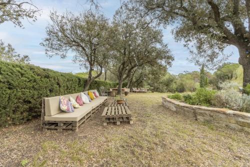 a couch and a table in a yard with trees at Sant Grau ii in Navés