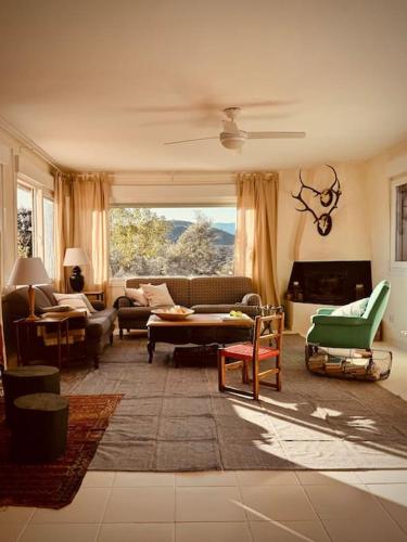 a living room filled with furniture and a large window at Casa en el Valle del Tietar CR-AV-01516 in Fresnedillas