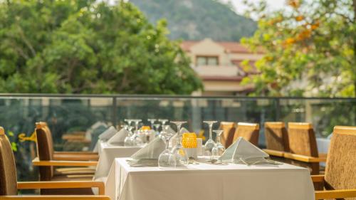 a table with white tablecloths and napkins on top at Sundia By Liberty Oludeniz in Oludeniz