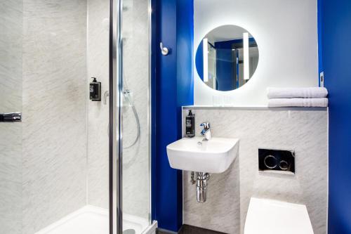 a bathroom with a sink and a shower at ibis budget Manchester Airport T2 in Hale