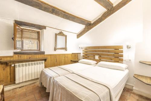 a bedroom with a large bed in a room at La Caseta De Sant Grau in Navés