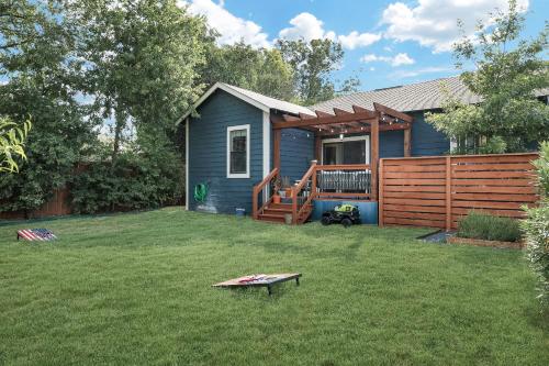 a small blue house with a fence and a yard at Getaway Near River Walk DT Yard BBQ Pet Games in San Antonio