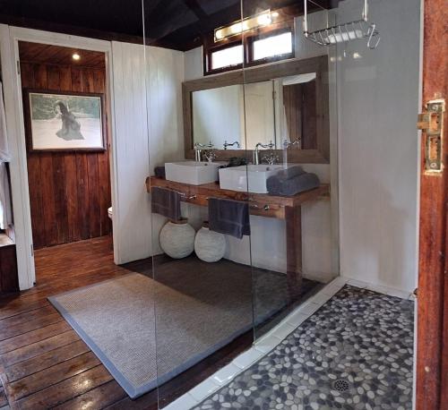 a bathroom with two sinks and a mirror at Barefoot Addo Elephant Lodge in Addo