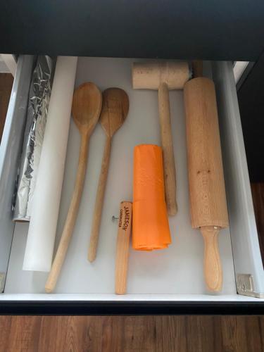 a drawer filled with lots of wooden utensils at Apartmán Victoria in Martin