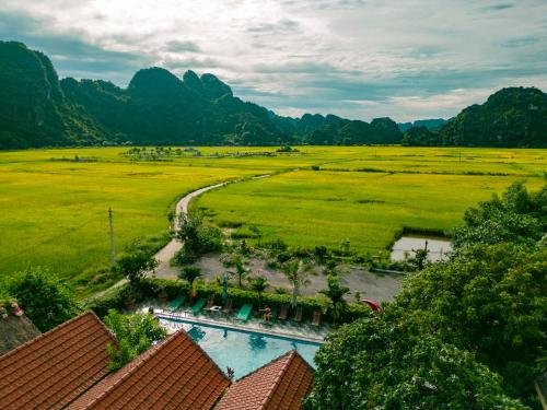 an aerial view of a field with mountains in the background at Tam Coc Minh Hung Homestay in Ninh Binh