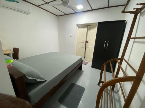 a small bedroom with a bed and a chair at VILLA 826 Ahungalla in Ahungalla