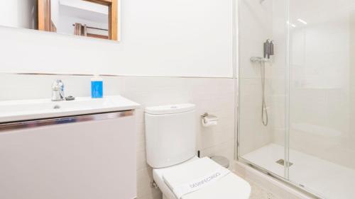 a bathroom with a toilet and a sink and a shower at Alcana Suites by Toledo AP in Toledo