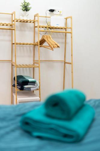a shelf with a blue pillow on a bed at WHITE PLATAN apartment in Iaşi