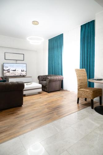 a living room with a couch and a table at WHITE PLATAN apartment in Iaşi