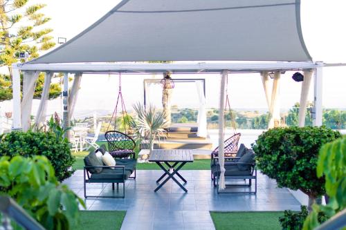 a gazebo with a table and chairs on a patio at Kasparis View Residence in Pano Lefkara
