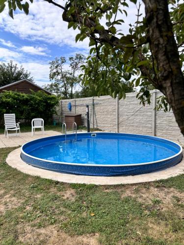 a large blue swimming pool in a yard at Chata 2 in Nový Přerov