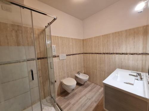 a bathroom with a shower and a toilet and a sink at Residence Ferrucci in Prato