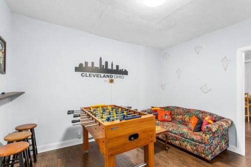 a living room with a couch and a table with dominoes at Stylish King Bed, 2BDRM, 1 Mile to DTWN, Game Room in Cleveland