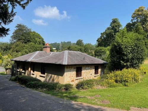 an old brick house on the side of a road at Marnwood Lodge in Coalbrookdale