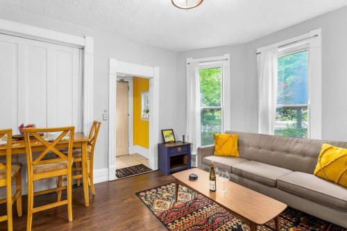 a living room with a couch and a table at Stylish King Bed, 2BDRM, 1 Mile to DTWN, Game Room in Cleveland