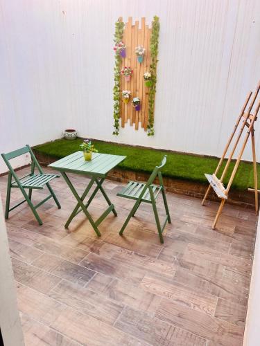 a patio with two chairs and a table and a wall at Apartment near airport mohammed V International Casablanca in Deroua