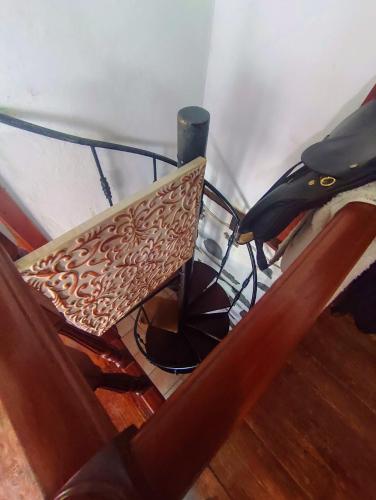 a chair and a table with a lamp in a room at Rivendell Eco lodge in El Paso