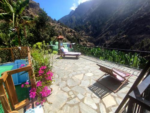 a patio with a view of a mountain at Rivendell Eco lodge in El Paso