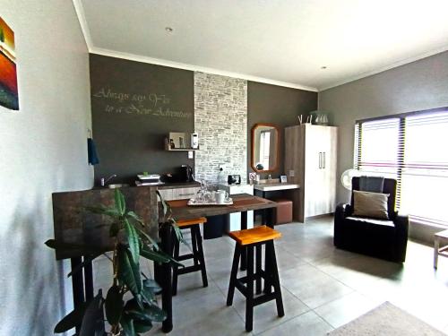 a kitchen and living room with a table and chairs at Silver Oaks Airbnb in Langebaan