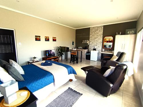 a bedroom with a bed and a living room at Silver Oaks Airbnb in Langebaan
