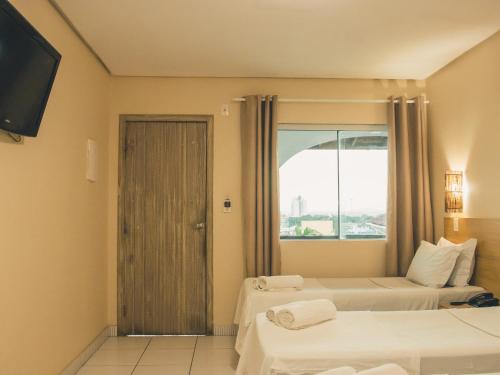 Ένα ή περισσότερα κρεβάτια σε δωμάτιο στο Hotel Brisa da Costa