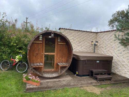 a large wooden gazebo with a hot tub at Casa Dudu in Moieciu de Jos