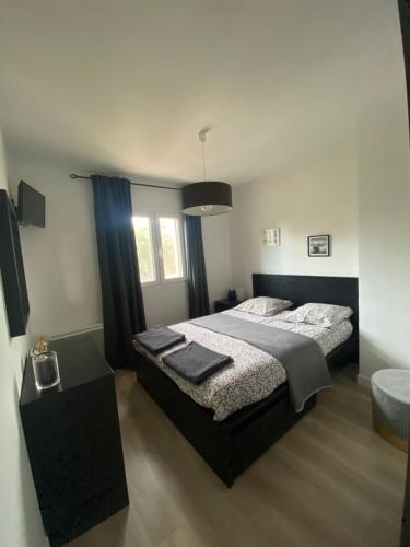 a bedroom with a large bed and a sink at Maison la Londe in La Londe-les-Maures