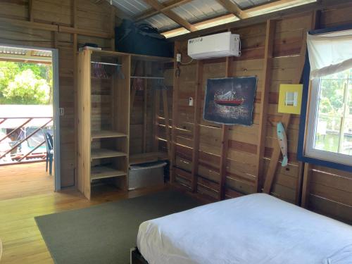 a bedroom with a bed and a book shelf at Oceanfront, Quiete and Convenient Location in Bocas del Toro