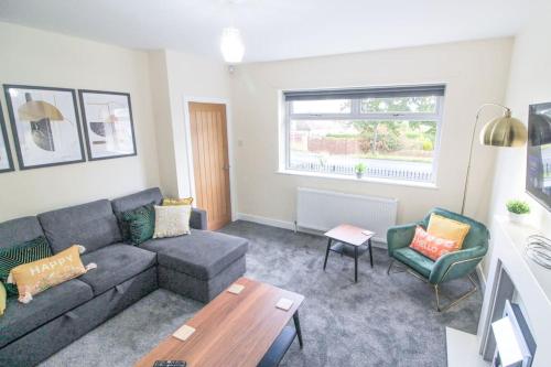 a living room with a couch and two chairs at Cosy Modern 3 Bedroom House in Bradford City in Wibsey