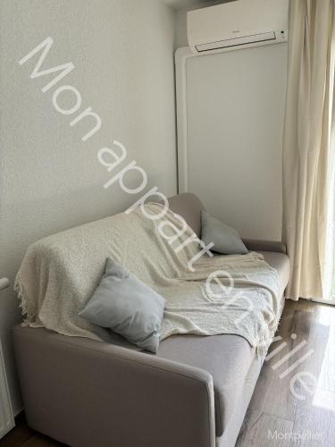 - un lit avec couverture dans une chambre dans l'établissement Mon Appart en Ville, à Montpellier