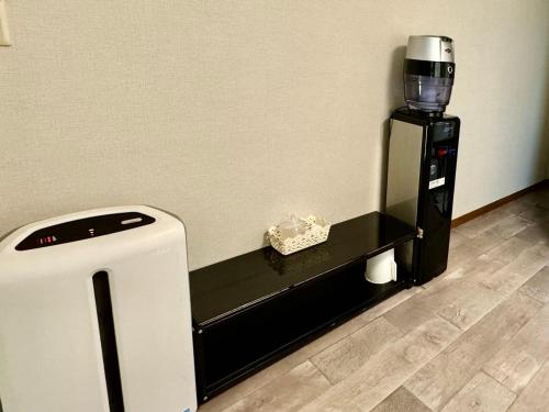 a coffee machine sitting on a shelf in a room at KOBAYASHi 東京 in Tokyo