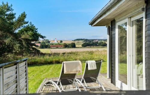 two chairs sitting on the porch of a house at 3 Bedroom Beautiful Home In Samsø in Nordby