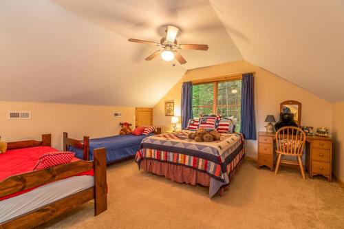 a bedroom with two beds and a ceiling fan at Hummingbird Hollow in Bryson City