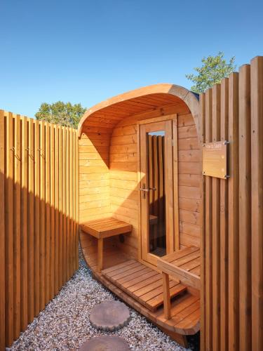 a wooden sauna in a wooden fence at Hannover - PHIL & MAX Hotels und Apartments Airport in Hannover